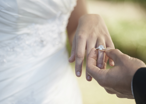 Woman is wearing a carat diamond engagement ring